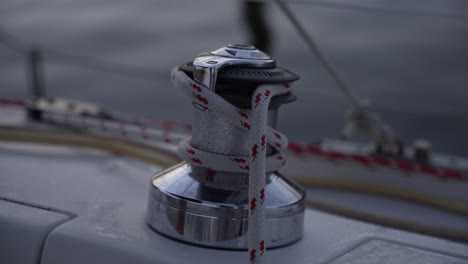 this stock video footage features a close-up detail shot of a winch on a sailboat