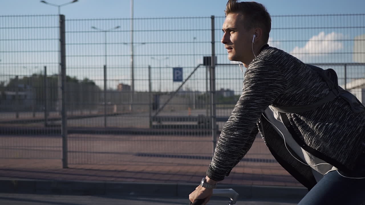 Man riding a bicycle with headphones on the street