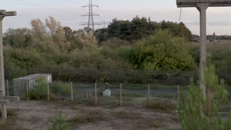 Close-up-of-derelict-and-unused-nuclear-power-station-with-green-fields-surrounding