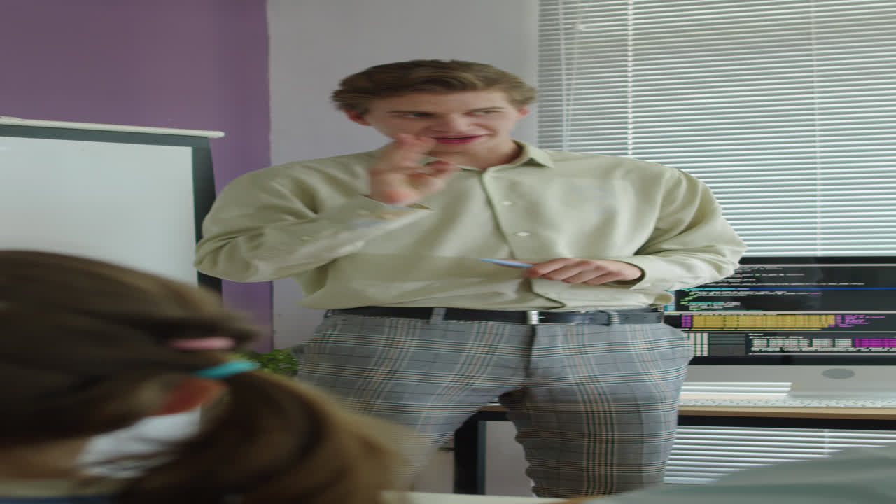 Tutor Asking Schoolchildren to Give Answers at Programming Class