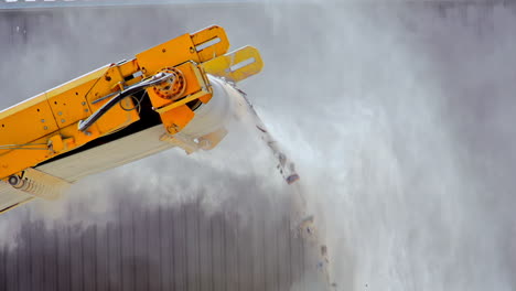 Rocks-and-dust-coming-off-the-conveyer-grader-belt-at-a-quarry---slow-motion