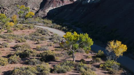 aerial shot of white suv driving along road through utah grasslands