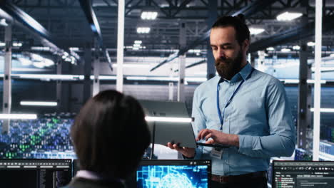 data center technician using laptop to monitor neural network ai llm