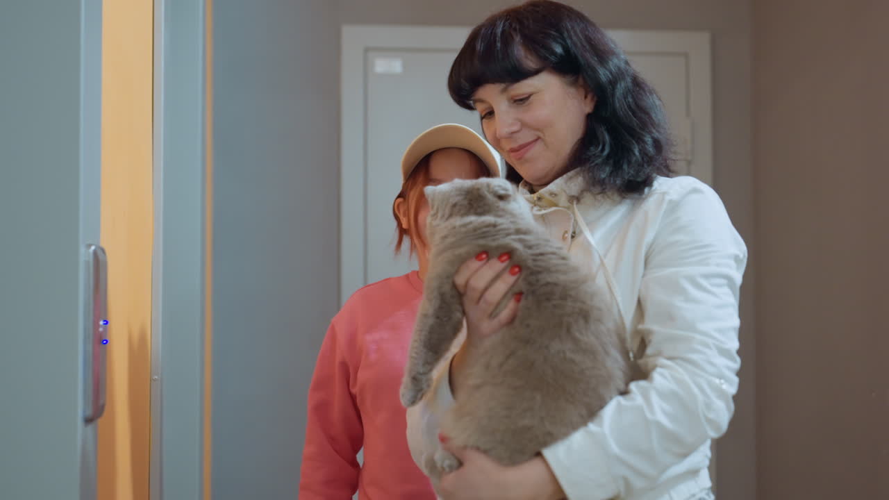 Warm Greeting Encounter, Friendly Corridor Meeting Where Woman Welcomes Child And Feline Affectionately, Charming Hallway Scene Of Woman Lovingly Greeting Her Child And Pet Cat Together
