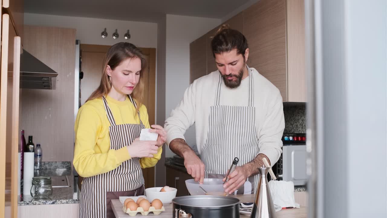Couple baking together in the kitchen