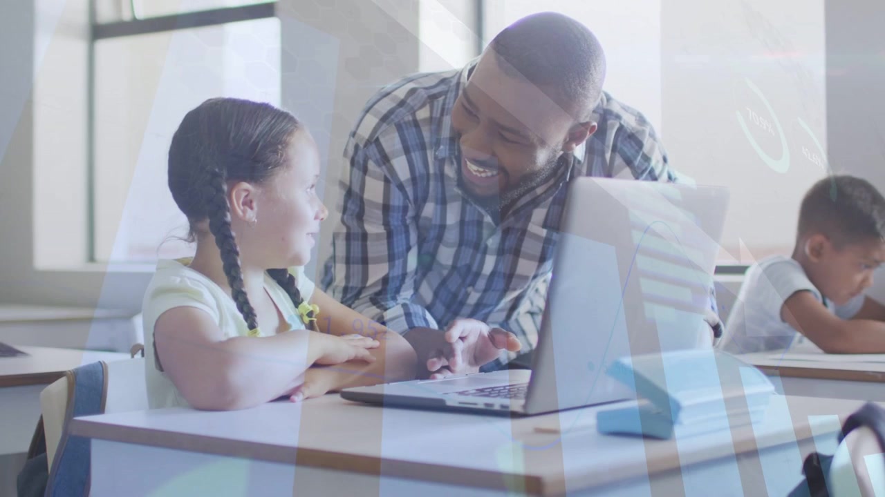 Male teacher leaning over pupil pointing at laptop and causing animated cues in school engaging kid
