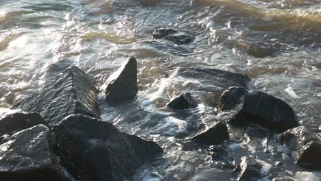 close up of the coastal barrier being hit by the rising sea waves