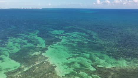 aerial view of clear turquoise ocean water and coral reefs