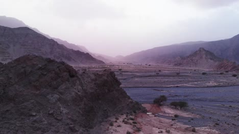 drone aerial shot of mountain valley reveal with car passing by