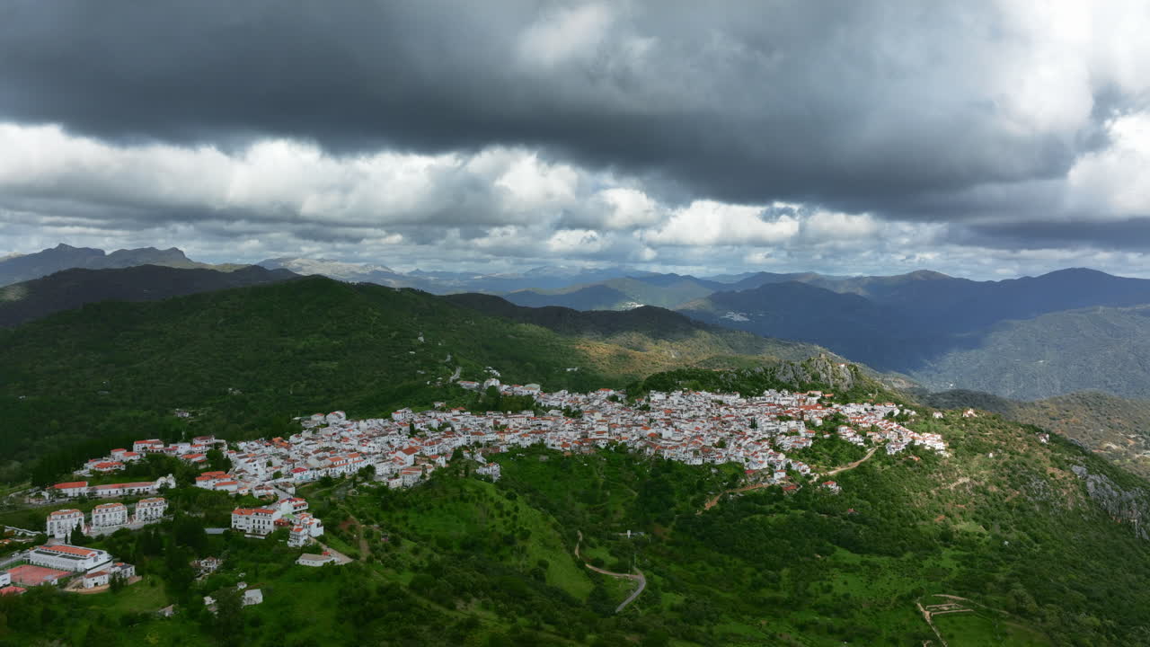 Beautiful cinematic drone view of Gaucín City in the mountains of Spain, Europe. Cloud shadows are covering mountains around. Descending camera movement. High quality 4K prores footage.