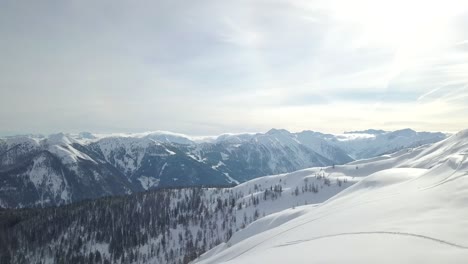 Solo-person-on-a-snowy-mountain,-snowboarding,-with-amazing-views-of-the-French-Alps