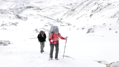 backpackers on larke pass in nepal, 5100m altitude. manaslu circuit trek area.