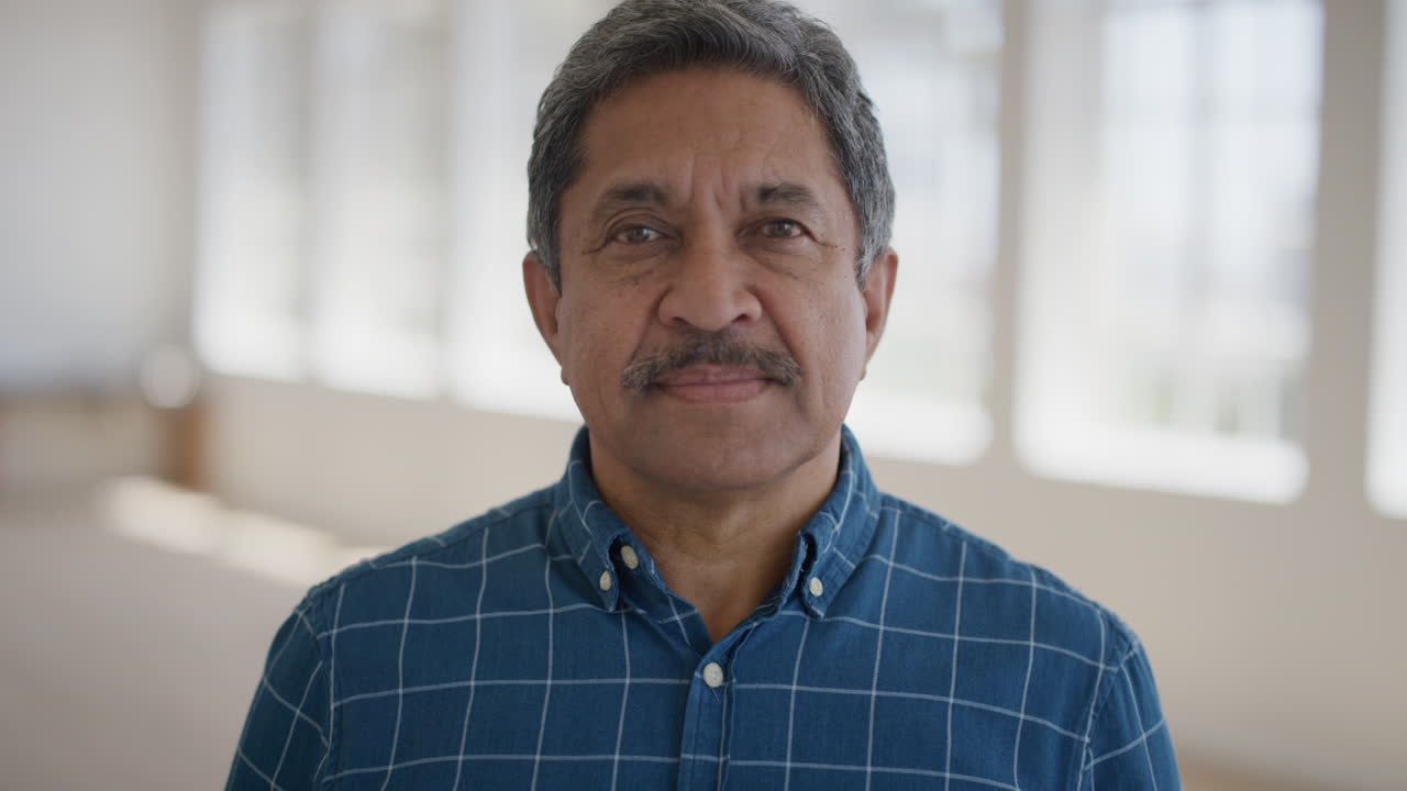 close up portrait of middle aged man looking serious at camera in calm successful retired senior male