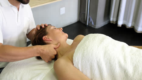 physiotherapist giving neck massage to a woman