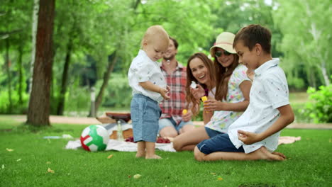 Parents-laughing-together-with-kids-outdoors.-Family-spending-weekend-in-forest