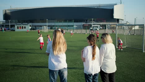 children's soccer practice with supportive parents