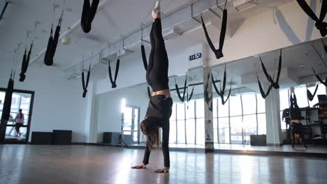 woman doing handstand in studio demonstrating strength and flexibility fitness workout woman doing handstand in studio demonstrating strength and flexibility fitness workout