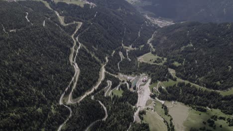 Drone-video-with-a-descriptive-frontal-plane-advancing,-over-a-sella-pass,-with-a-mountain-on-the-horizon