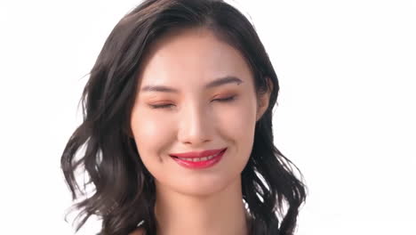 Portrait-happy-young-girl-with-flying-hair-smiling-with-lots-of-makeup-brushes,-surrounded-by-a-variety-of-cosmetics,-eyeshadows-and-lipstick