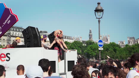 transgender person overlooking the crowd from the back of the truck at the pride parade in paris, france.the video is slowed down to 30 frames from 120.