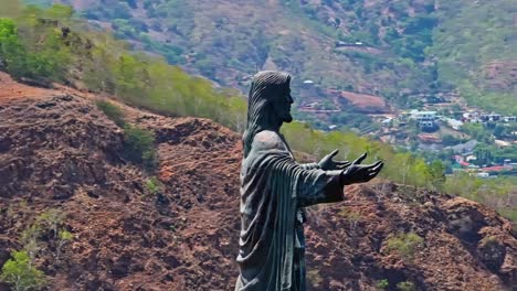 Cape-Fatucama,-Dili,-East-Timor---Cristo-Rei-of-Dili-Statue---Aerial-Panning-Shot