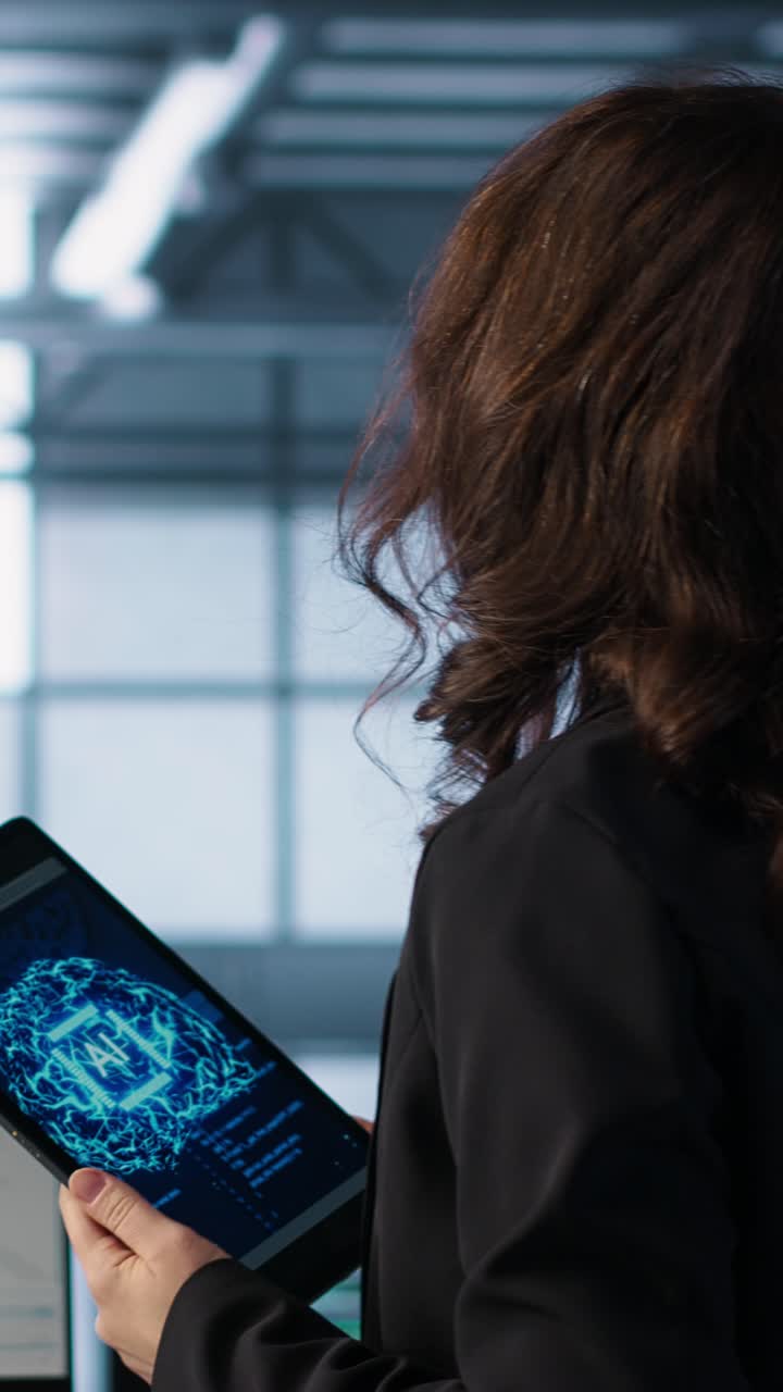 Vertical video Technician in data center with tablet integrating AI driven automation tools