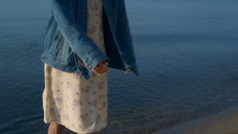 stylish girl spending leisure time at sea in summer. happy woman posing on beach