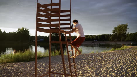 male lifeguard going up to the watchtower