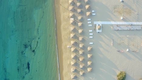 Blick-Von-Oben-Nach-Unten-Auf-Unberührtes-Wasser-Strandufer-Mit-Sonnenschirmen-Auf-Sand,-Strand-Von-Milopotas