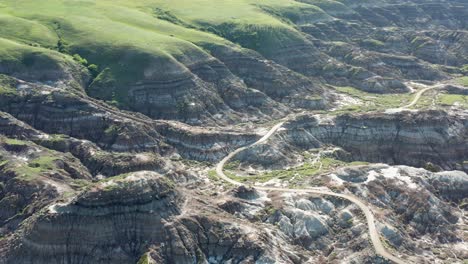 high aerial pass over badlands and terrain in alberta, canada