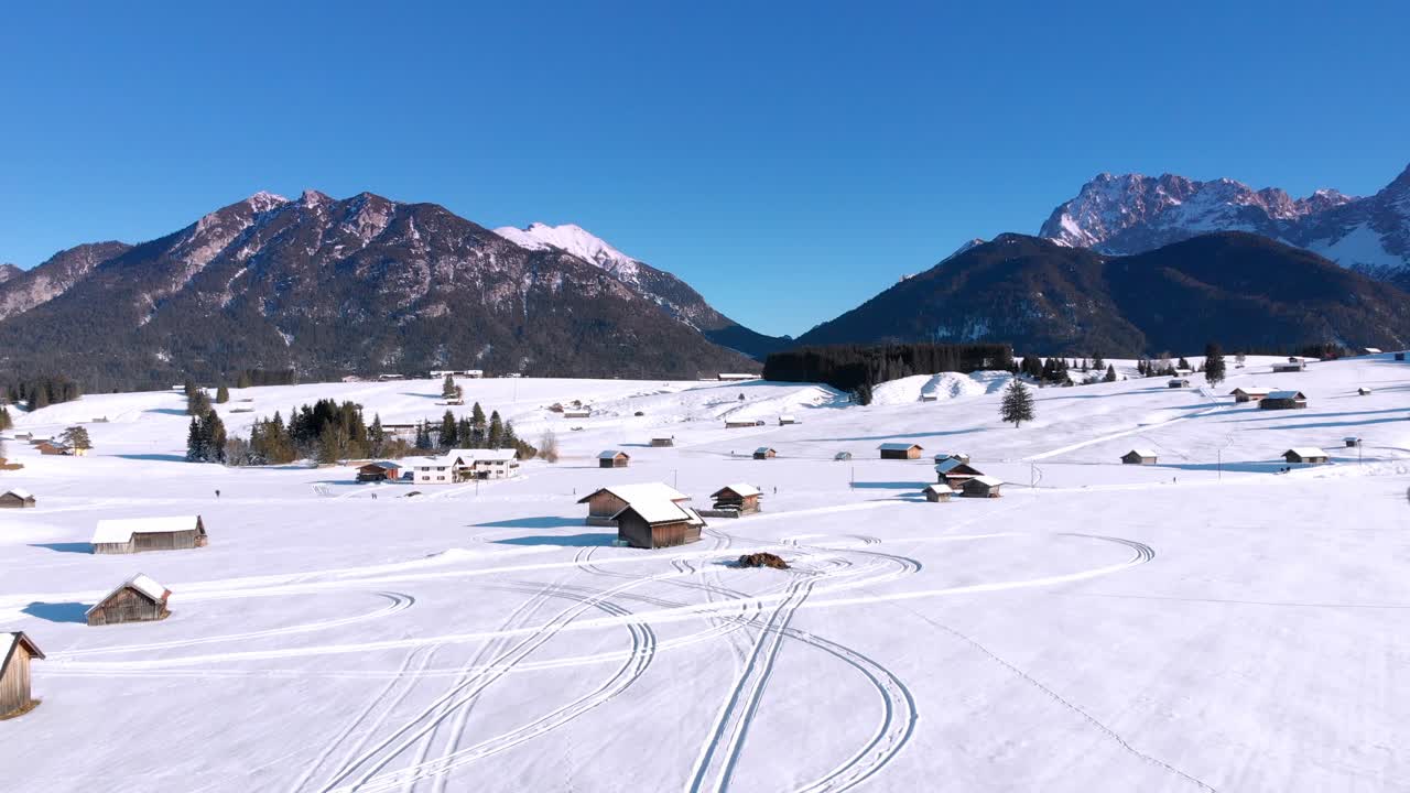 Aerial: drone flying over a rural area with some snow in the Karwendel mountains near Mittenwald in Bavaria, Germany