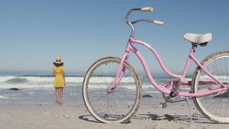 african american woman seaside with a bike