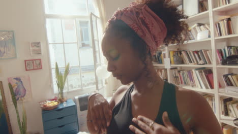 young black girl dancing on camera in sunlit room