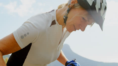 Senior-cyclist-checking-bicycle-at-countryside-4k