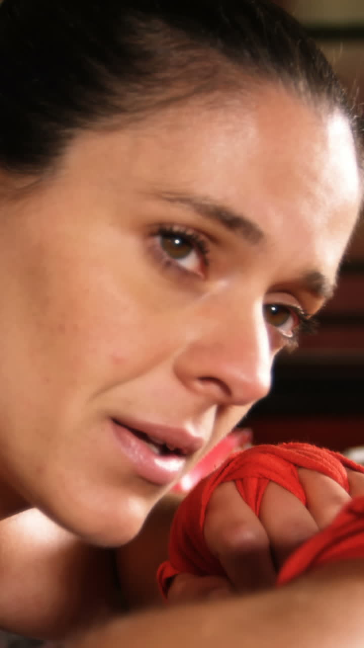 Tired female boxer standing in the ring