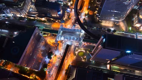 time lapse of aerial view of intersection or junction with cars traffic, bangkok downtown. thailand. financial district and business centers in smart urban city. skyscraper and buildings at night.