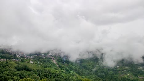 Stadt-Eingebettet-In-Bergkette-Mit-Sich-Schnell-Bewegenden-Weißen-Wolken-Am-Morgen-Aus-Flachem-Winkel