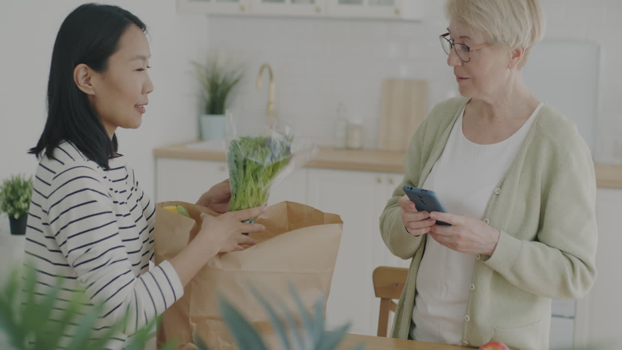 Elderly woman and young woman shopping for groceries