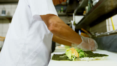 Male-chef-preparing-sushi-in-kitchen-4k