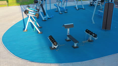 Outdoor-Gym-Equipment-in-a-Public-Park-in-Aerial-View-during-Golden-sunlight