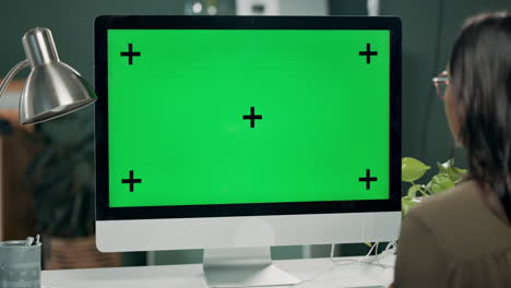 computer with green screen and woman