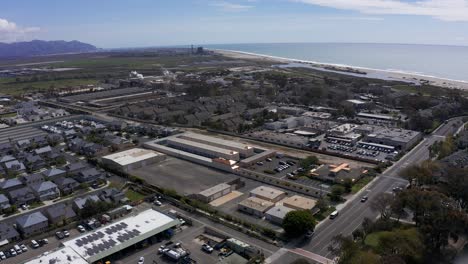 Aerial-high-panning-shot-of-an-industrial-complex-in-Port-Hueneme-along-the-Pacific-Ocean-in-California