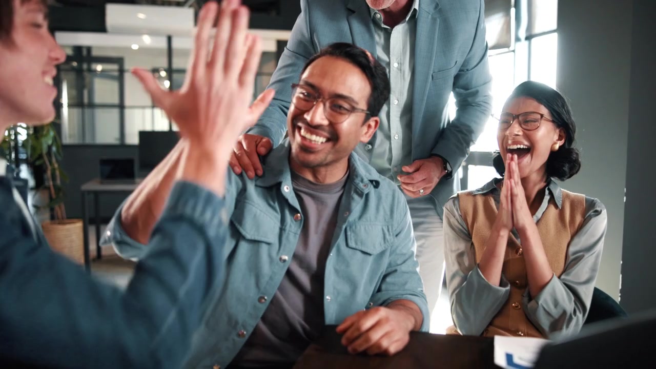 Diverse Business Team Celebrating Success in Modern Office