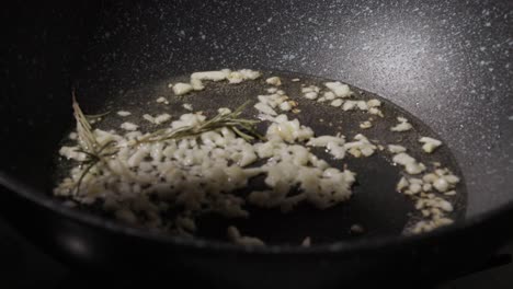 frying of garlic in a frying pan - close up