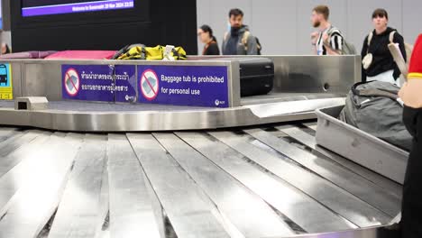 passengers retrieving bags at baggage claim