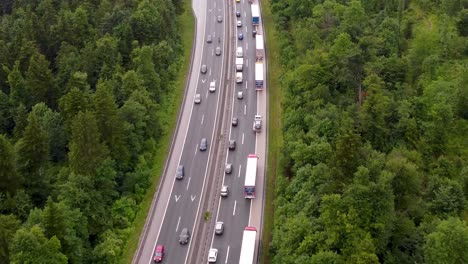 zoomed-inemergency lane forming on a 2-lane highway due to traffic accident with heavy traffic making congestion in a small european country from a drone