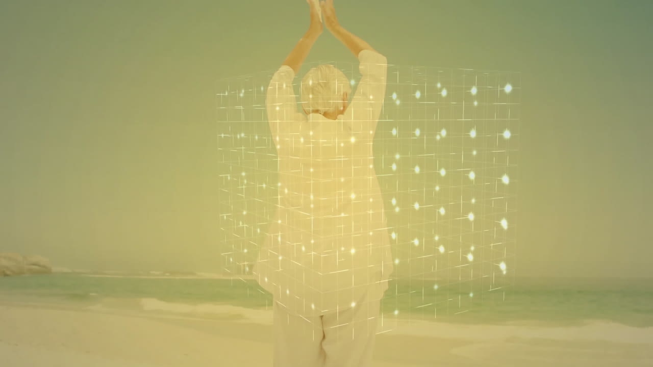 Practicing yoga on beach, elderly person with digital animation grid overlay