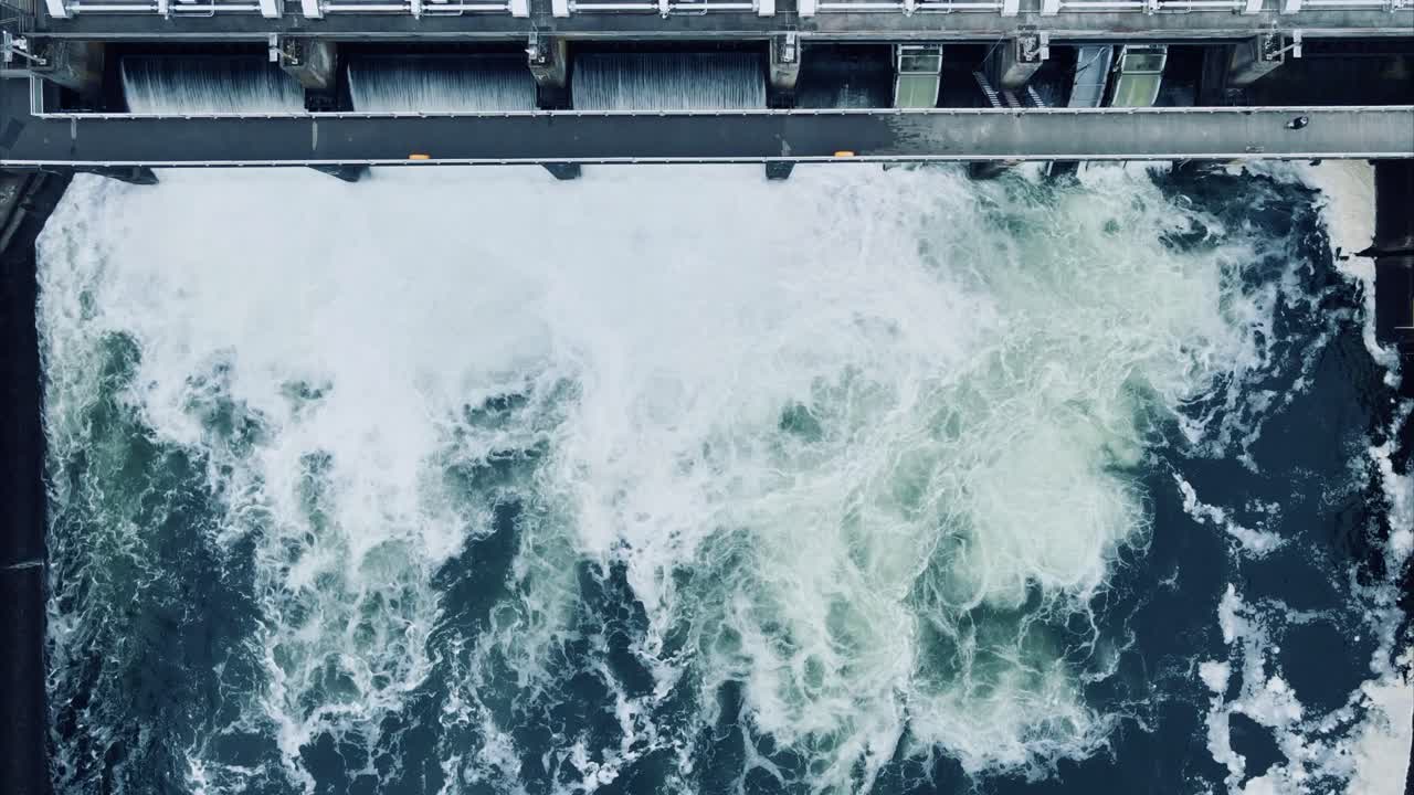 Stationary, bird's-eye view of slow motion water rushing through the Ballard Locks in Seattle, Washington