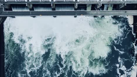 stationary, bird's-eye view of slow motion water rushing through the ballard locks in seattle, washington