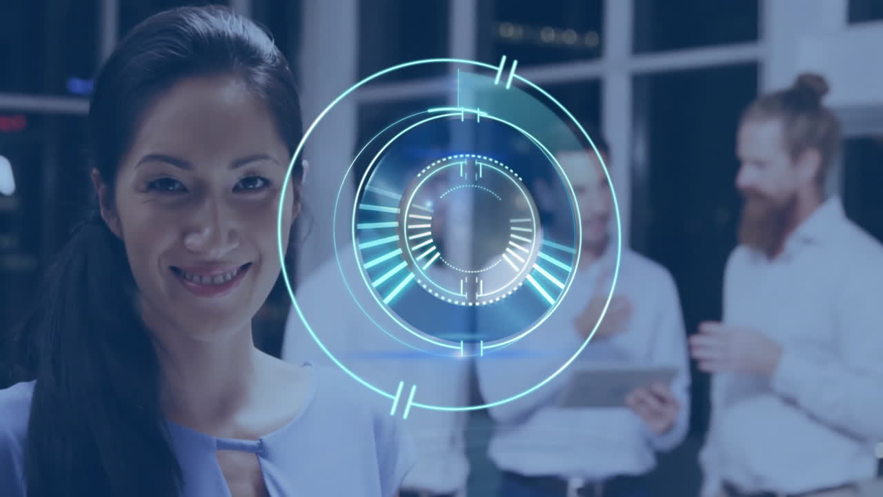 Smiling woman with digital interface, colleagues discussing in background at office